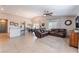 Open-concept living room with tiled floors, ceiling fan, and lots of natural light at 4508 Dragon Fly Creek Ave, North Las Vegas, NV 89031