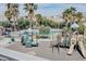 Community playground with multiple slides and climbing structures, near palm trees and a pool at 4508 Dragon Fly Creek Ave, North Las Vegas, NV 89031