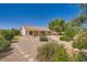 Well-manicured backyard with lush greenery, decorative rocks, and a covered patio at 4904 Meadows Encore Ave, Las Vegas, NV 89131