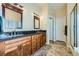 Bathroom with a double sink vanity and a doorway into the main bedroom at 4904 Meadows Encore Ave, Las Vegas, NV 89131