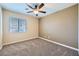 Neutral bedroom with ceiling fan, wall-to-wall carpeting, and natural light at 4904 Meadows Encore Ave, Las Vegas, NV 89131