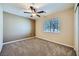 Cozy bedroom with a ceiling fan, plush carpeting and natural light at 4904 Meadows Encore Ave, Las Vegas, NV 89131