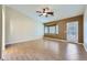 Bright bedroom with wood floors, a ceiling fan, and a private patio entrance at 4904 Meadows Encore Ave, Las Vegas, NV 89131
