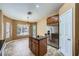 An eat-in kitchen area features an island, stainless steel refrigerator, and natural light at 4904 Meadows Encore Ave, Las Vegas, NV 89131