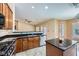 Well-lit kitchen with stainless steel appliances, an island, and black countertops at 4904 Meadows Encore Ave, Las Vegas, NV 89131