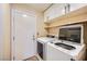 Convenient laundry room with modern appliances and ample cabinet space at 4904 Meadows Encore Ave, Las Vegas, NV 89131