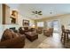 Cozy living room featuring a fireplace, neutral paint, and a ceiling fan at 4904 Meadows Encore Ave, Las Vegas, NV 89131