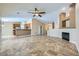 Open-concept living space flows into the kitchen with tile floors and a fireplace at 4904 Meadows Encore Ave, Las Vegas, NV 89131