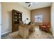 Home office with a desk, bookshelf, and a comfortable plaid arm chair at 4904 Meadows Encore Ave, Las Vegas, NV 89131