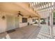 A covered outdoor patio featuring dual ceiling fans, with a lattice pergola providing shade at 4904 Meadows Encore Ave, Las Vegas, NV 89131
