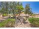 Well-maintained yard with lush landscaping and mature trees create a serene outdoor space at 4904 Meadows Encore Ave, Las Vegas, NV 89131