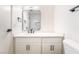 Modern bathroom featuring sleek fixtures, a large mirror, and white cabinets at 50 Armstrong Cir, Henderson, NV 89015
