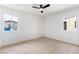 Bright bedroom featuring wood floors, two windows, and a ceiling fan at 50 Armstrong Cir, Henderson, NV 89015