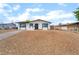 Well-maintained single-story home boasting a tidy rock garden, complemented by a clear blue sky at 50 Armstrong Cir, Henderson, NV 89015