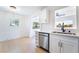 Bright kitchen features modern white cabinets, stainless steel dishwasher, and stylish lighting at 50 Armstrong Cir, Henderson, NV 89015