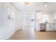 Bright living room with hardwood floors connecting to an open kitchen with modern appliances at 50 Armstrong Cir, Henderson, NV 89015