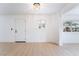 Bright, open living room with hardwood flooring and modern lighting fixture at 50 Armstrong Cir, Henderson, NV 89015