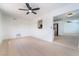 Open-concept living room with a ceiling fan and seamless flow into the adjacent kitchen at 50 Armstrong Cir, Henderson, NV 89015