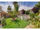 Backyard oasis featuring a pool, palm tree, lush landscaping and beautiful desert flora at 5004 Ironhorse Ranch Ave, Las Vegas, NV 89131
