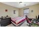 Bedroom featuring a bed, desk, and gaming chair in a carpeted room at 5004 Ironhorse Ranch Ave, Las Vegas, NV 89131