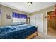 Bedroom features a queen-size bed, plush carpet, and a closet for storage at 5004 Ironhorse Ranch Ave, Las Vegas, NV 89131