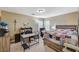 Comfortable bedroom features a bed, desk, chair, and window with natural light at 5004 Ironhorse Ranch Ave, Las Vegas, NV 89131