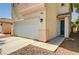 Two-story home featuring a two-car garage, desert landscaping, and a tile roof at 5004 Ironhorse Ranch Ave, Las Vegas, NV 89131