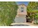 Two-story home featuring a two-car garage, desert landscaping, and a tile roof at 5004 Ironhorse Ranch Ave, Las Vegas, NV 89131