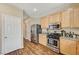 Bright kitchen area with stainless steel appliances, wood cabinets, and hardwood floors for modern living at 5004 Ironhorse Ranch Ave, Las Vegas, NV 89131