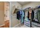 Organized walk-in closet adjacent to a bathroom, maximizing space and functionality at 5004 Ironhorse Ranch Ave, Las Vegas, NV 89131