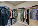 Organized walk-in closet with hanging clothes, shelving, and storage solutions for clothing at 5004 Ironhorse Ranch Ave, Las Vegas, NV 89131