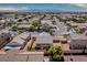 Panoramic aerial view capturing a backyard with pergola, artificial turf, surrounded by a desert landscape at 5028 Crying Heart St, North Las Vegas, NV 89031