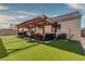 Backyard featuring a covered patio and a green lawn at 5028 Crying Heart St, North Las Vegas, NV 89031