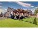 Backyard featuring a covered patio and a green lawn at 5028 Crying Heart St, North Las Vegas, NV 89031
