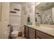 Bathroom with framed art above toilet and vanity at 5028 Crying Heart St, North Las Vegas, NV 89031