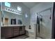 Clean bathroom featuring double sinks, a glass-enclosed shower, and a soaking tub for relaxation at 5028 Crying Heart St, North Las Vegas, NV 89031