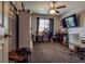 Bedroom with a ceiling fan, TV, sewing machine and workstation at 5028 Crying Heart St, North Las Vegas, NV 89031