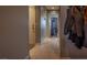Tiled hallway and a jacket rack, providing a view into the connected kitchen and dining area at 5028 Crying Heart St, North Las Vegas, NV 89031