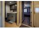 Functional laundry area with modern machines, storage cabinets, and easy access to the adjacent bedroom at 5028 Crying Heart St, North Las Vegas, NV 89031