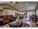 Spacious living room featuring tile flooring, comfortable seating, and an open layout to the kitchen at 5028 Crying Heart St, North Las Vegas, NV 89031