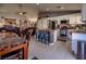 Open-concept living area featuring a kitchen with island seating, dining area, and comfortable seating at 5028 Crying Heart St, North Las Vegas, NV 89031