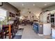 Open-concept living area, featuring a dining area and a connected kitchen with an island and bar stool seating at 5028 Crying Heart St, North Las Vegas, NV 89031