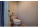 A compact toilet in a small, brightly lit room. Includes a white toilet and adjacent wall at 5028 Crying Heart St, North Las Vegas, NV 89031