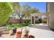The backyard features a covered patio and verdant landscaping that creates a serene outdoor retreat at 5240 Adorato Dr, North Las Vegas, NV 89031