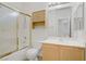 Well-lit bathroom features a tub and shower, a single sink vanity with a cabinet, and a medicine cabinet at 5240 Adorato Dr, North Las Vegas, NV 89031