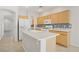 Functional kitchen boasts light wood cabinets, white appliances, and a mosaic backsplash at 5240 Adorato Dr, North Las Vegas, NV 89031