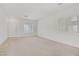 Clean and bright living room featuring neutral walls and two windows allowing plenty of natural light at 5240 Adorato Dr, North Las Vegas, NV 89031