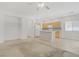 Bright living room blends seamlessly with an open kitchen, featuring tile floors and neutral tones at 5240 Adorato Dr, North Las Vegas, NV 89031