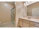 Well-lit bathroom featuring a glass-enclosed shower and a vanity with a neutral countertop at 5250 S Rainbow Blvd # 2101, Las Vegas, NV 89118