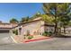 A beige condo building with a tile roof and mature trees enhancing its curb appeal at 5250 S Rainbow Blvd # 2101, Las Vegas, NV 89118